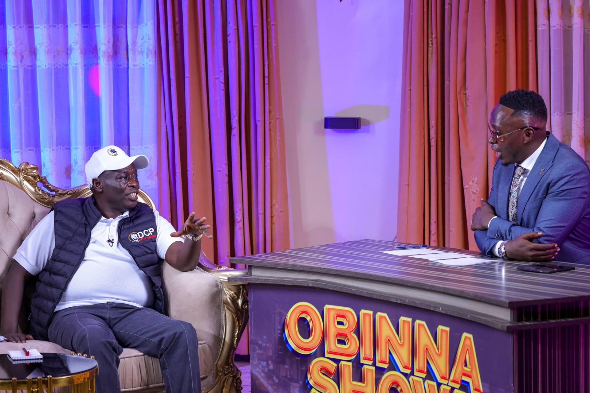 Rigathi Gachagua in a DCP cap speaking with Obinna on set